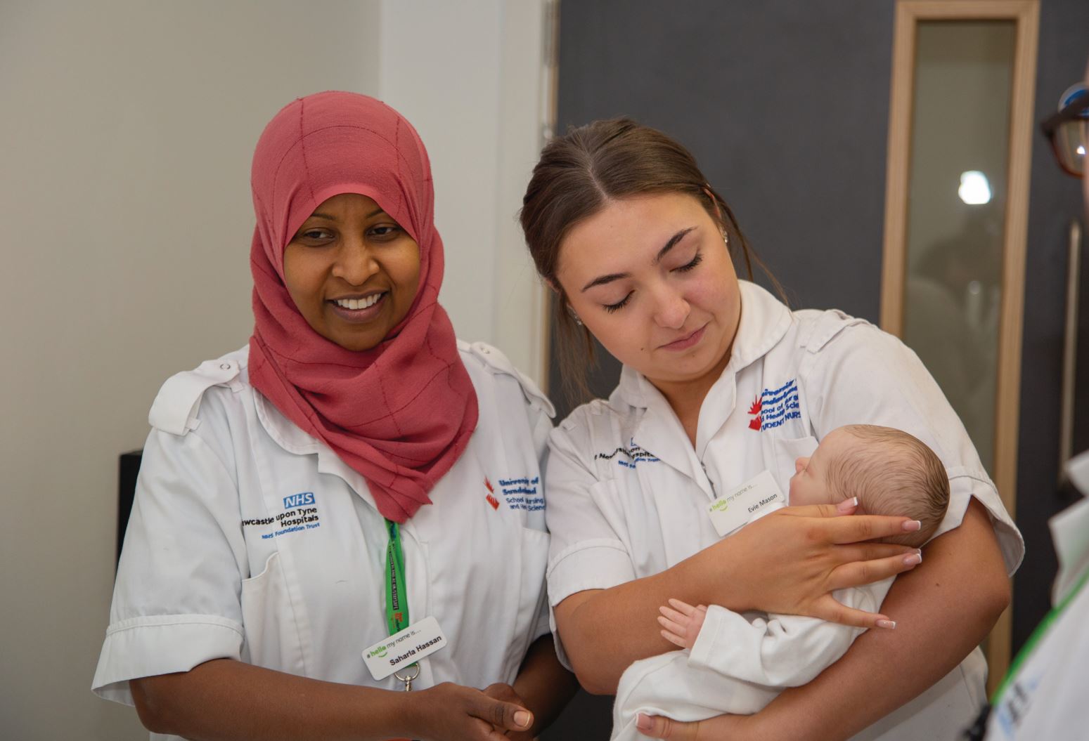 image of student nurses with a baby