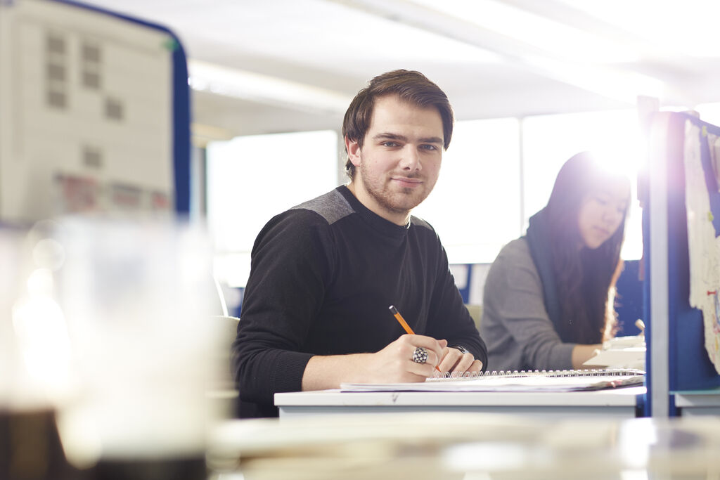 A student looks through a large portfolio