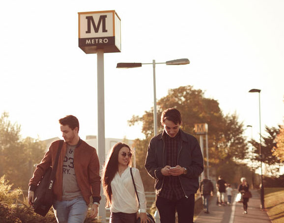 Students walking on path away from a Metro Station